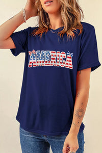 Person wearing a navy blue t-shirt with 'AMERICA' printed in red, white, and blue.
