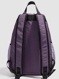 Purple backpack with black straps on a light gray background