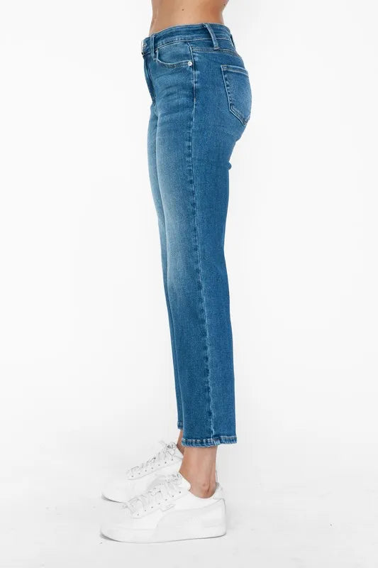 Blue jeans worn by a person on a white background