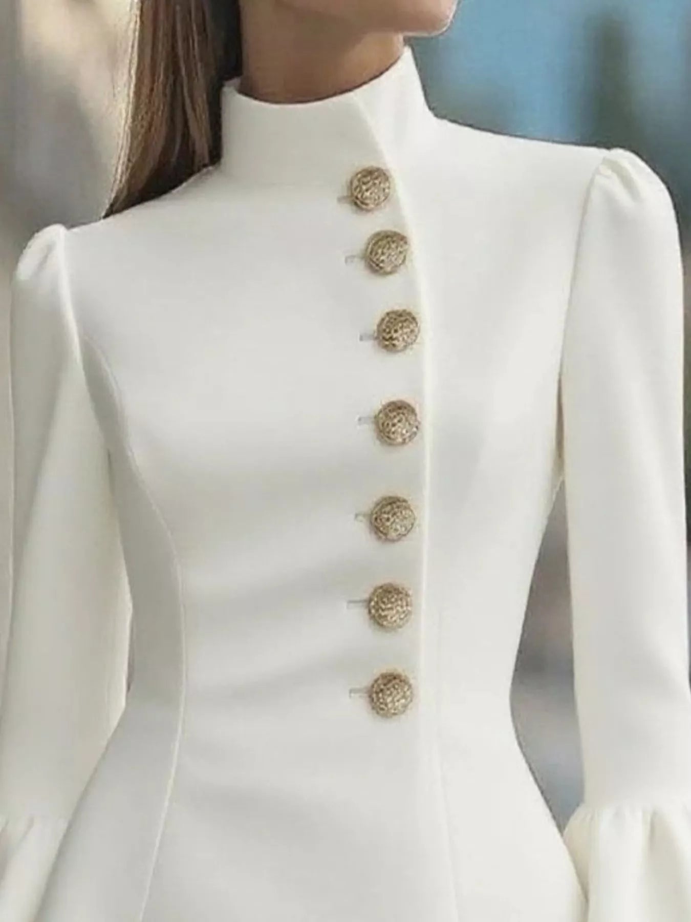 White coat with gold buttons on a blurred background