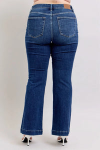 Blue jeans worn by a person on a white background
