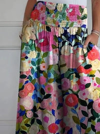 Colorful floral dress with a patterned top worn by a person.