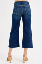 Blue jeans worn by a person on a white background