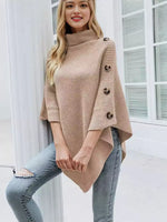 Woman wearing a beige poncho with buttons indoors