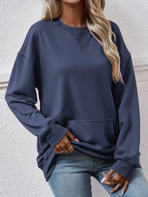 Person wearing a navy blue sweatshirt with a neutral background