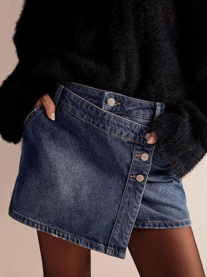 Person wearing a black fur coat and denim skirt on a beige background