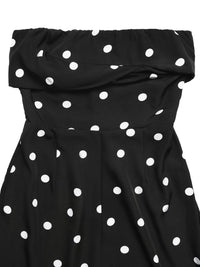Black strapless dress with white polka dots on a white background