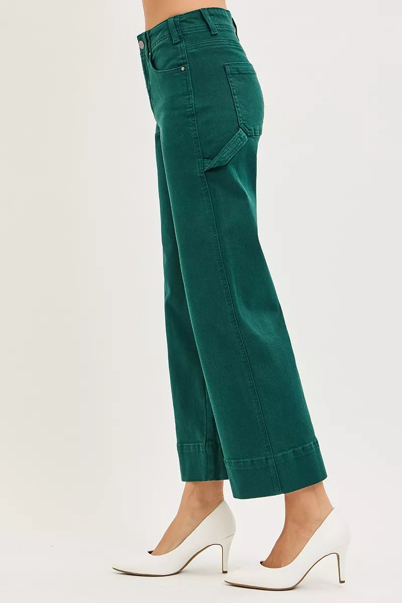 Green pants worn by a person on a white background
