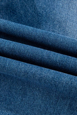 Close-up of blue denim fabric with a textured pattern