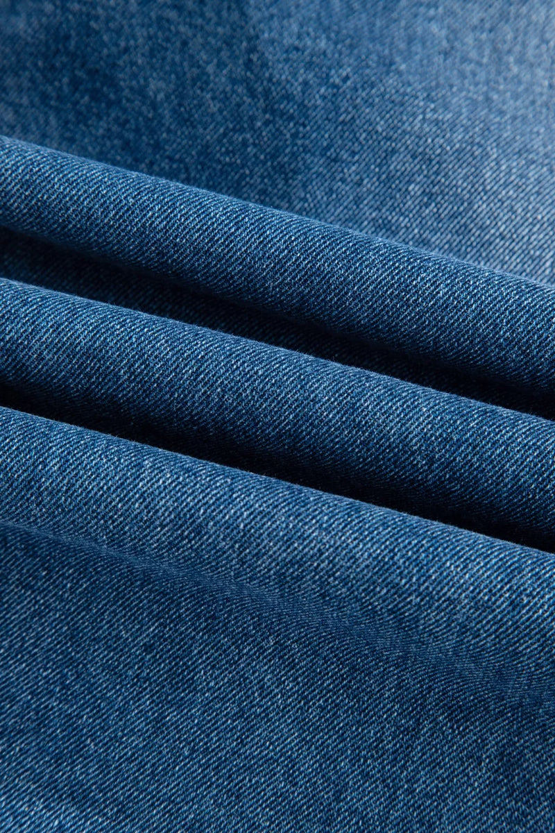 Close-up of blue denim fabric with a textured pattern