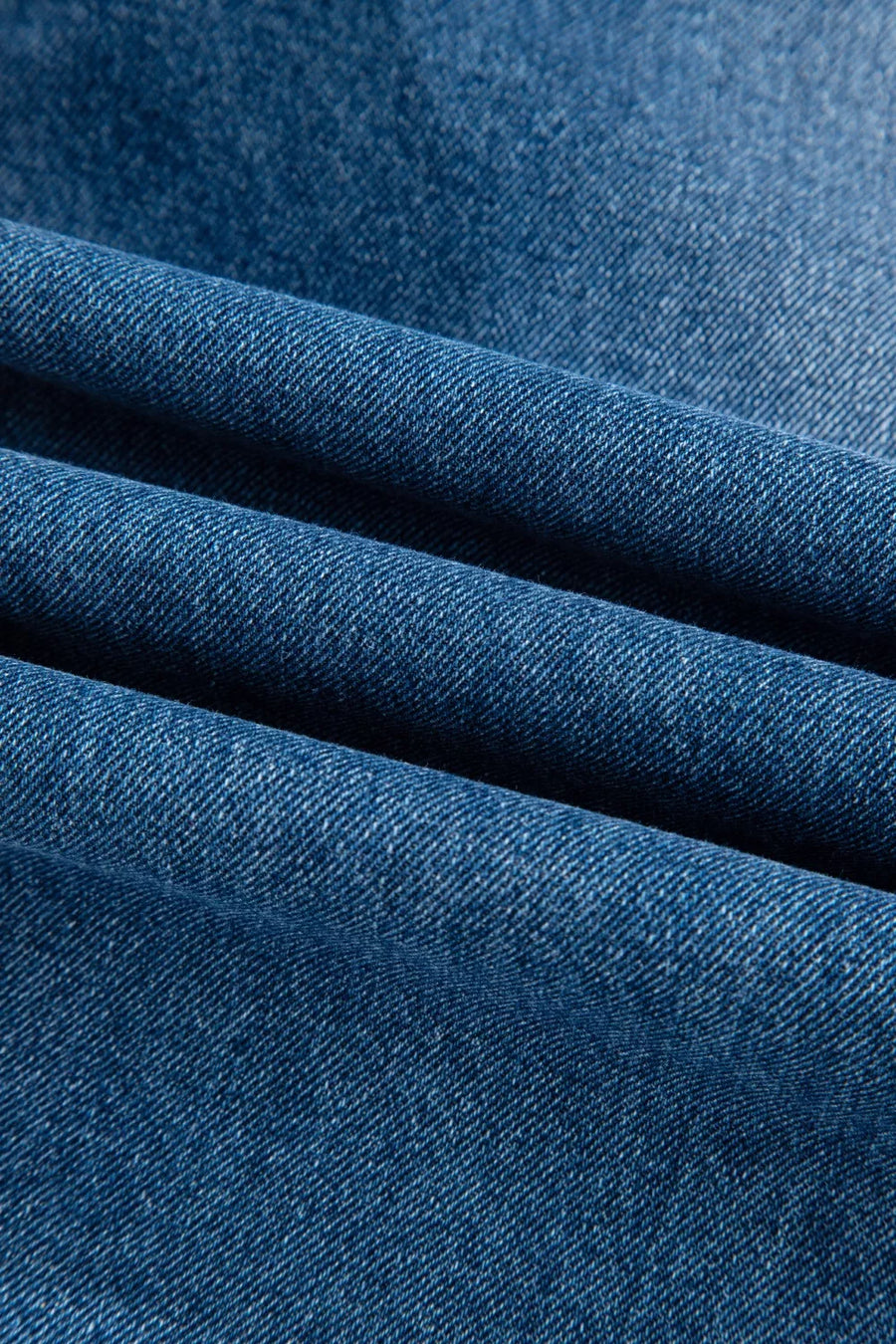 Close-up of blue denim fabric with a textured pattern