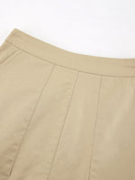 Close-up of beige pants with a white background