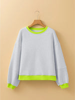 Gray sweatshirt with green trim on a beige background