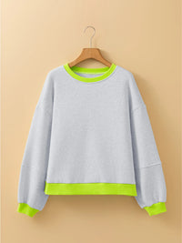 Gray sweatshirt with green trim on a beige background