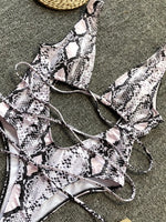 Snake print bikini set on a textured surface