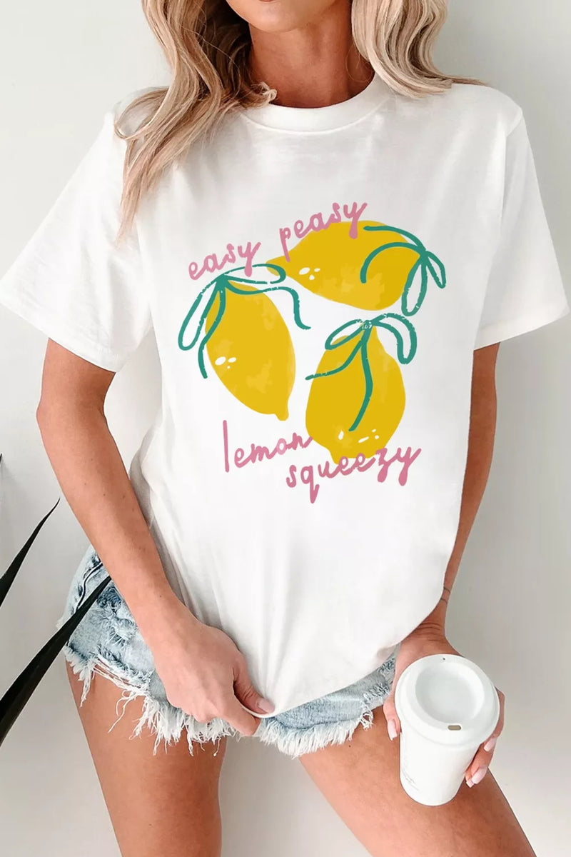 Person wearing a white t-shirt with lemon graphic and text