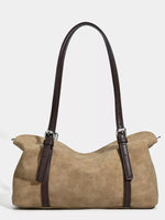 Beige handbag with brown straps on a white background