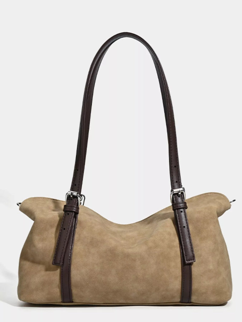 Beige handbag with brown straps on a white background