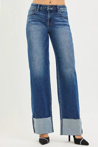 Blue jeans with cuffed hems on a white background