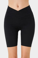Black shorts worn by a person on a white background