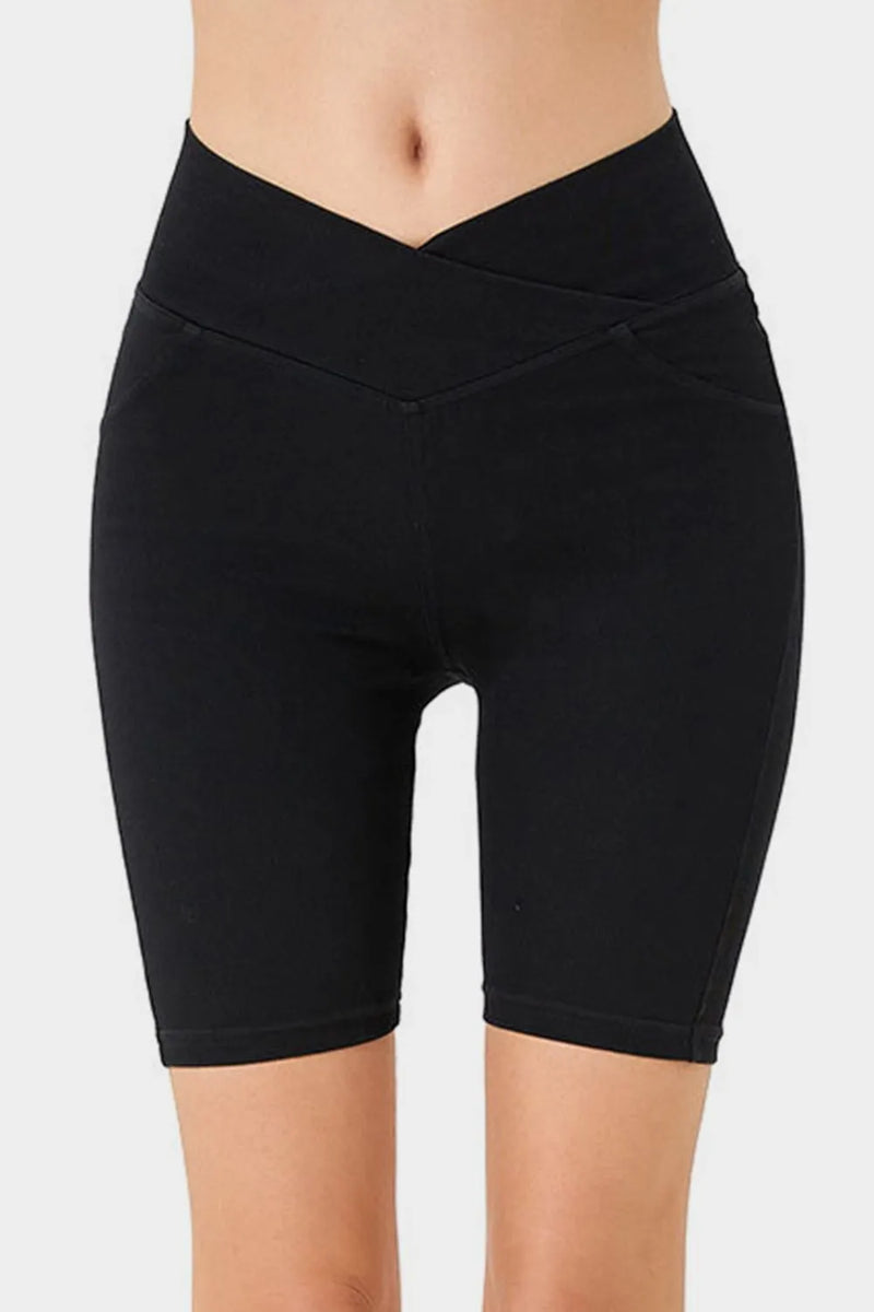 Black shorts worn by a person on a white background