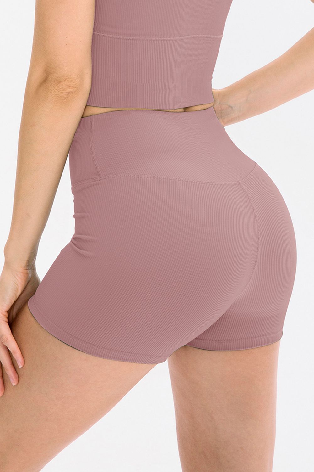Mauve ribbed shorts worn by a person on a white background
