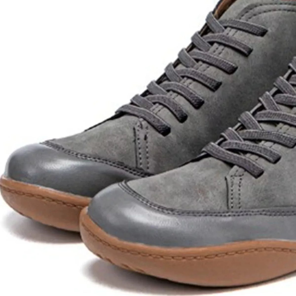 Gray high-top sneakers with brown soles on a white background