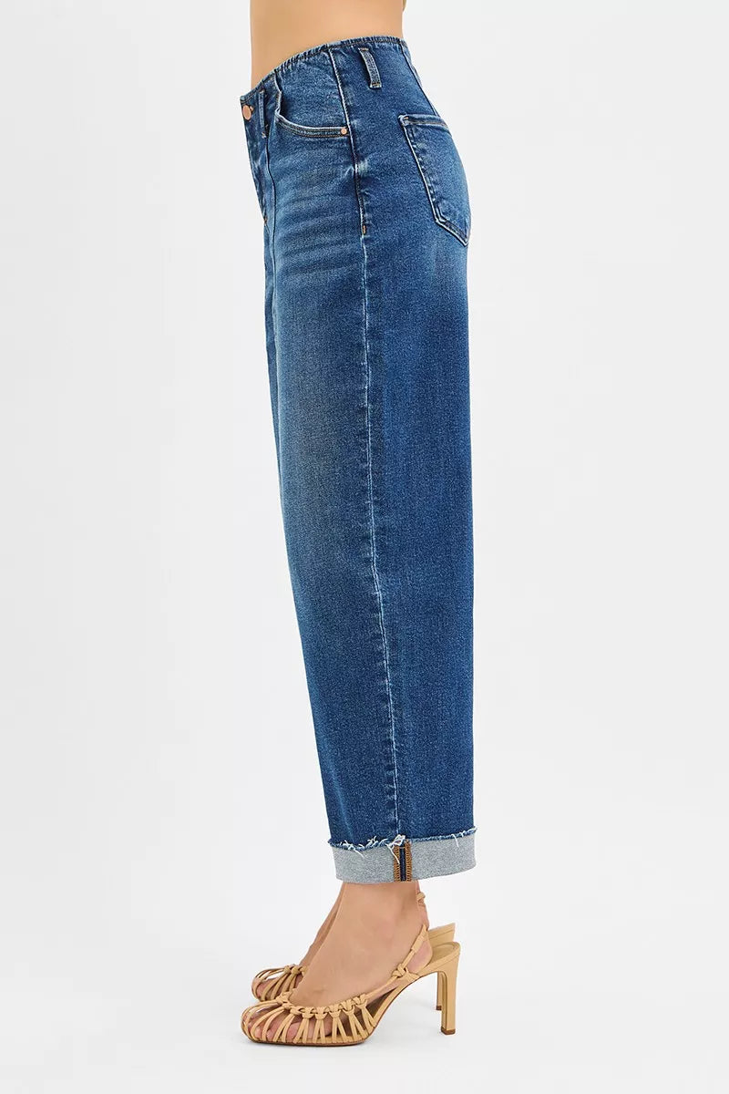 Blue jeans worn by a person on a white background
