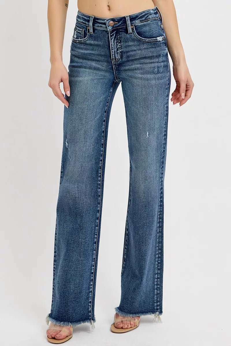 Blue jeans worn by a person on a white background