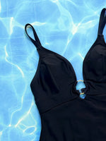 Black swimsuit on a blue water background