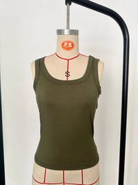 Green tank top on a mannequin with a white background