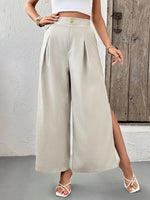 Person wearing beige wide-leg pants with a wooden door in the background