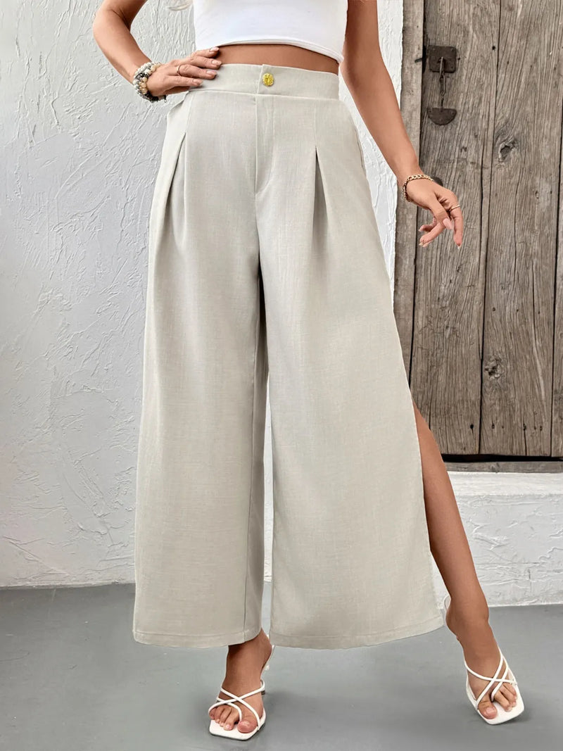 Person wearing beige wide-leg pants with a wooden door in the background