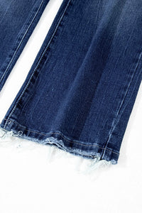 Close-up of blue jeans with lace trim on a white background
