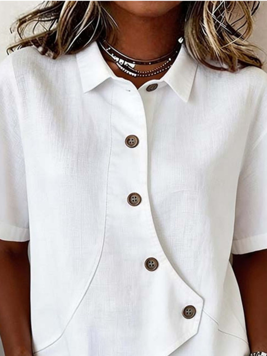 White button-up shirt with brown buttons worn by a person