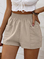 Beige shorts worn by a person against a light background