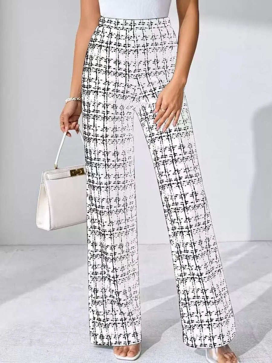 Person wearing black and white plaid pants holding a white handbag on a light gray background