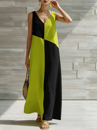 Woman wearing a black and yellow dress against a stone wall background