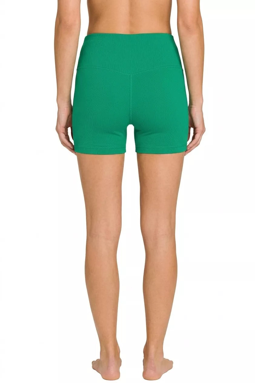 Green athletic shorts worn by a person on a white background
