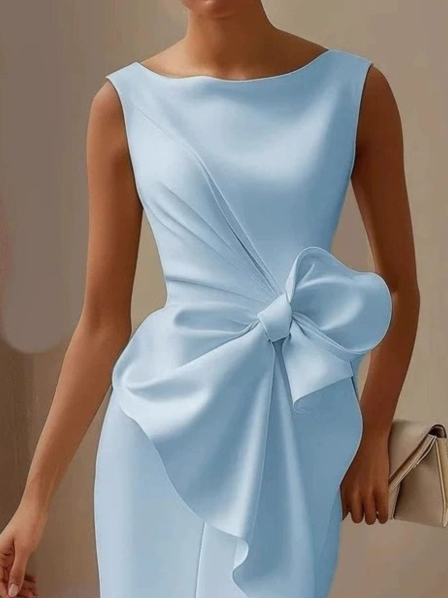 Light blue dress with a large bow detail on a neutral background