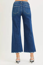 Blue jeans worn by a person on a white background