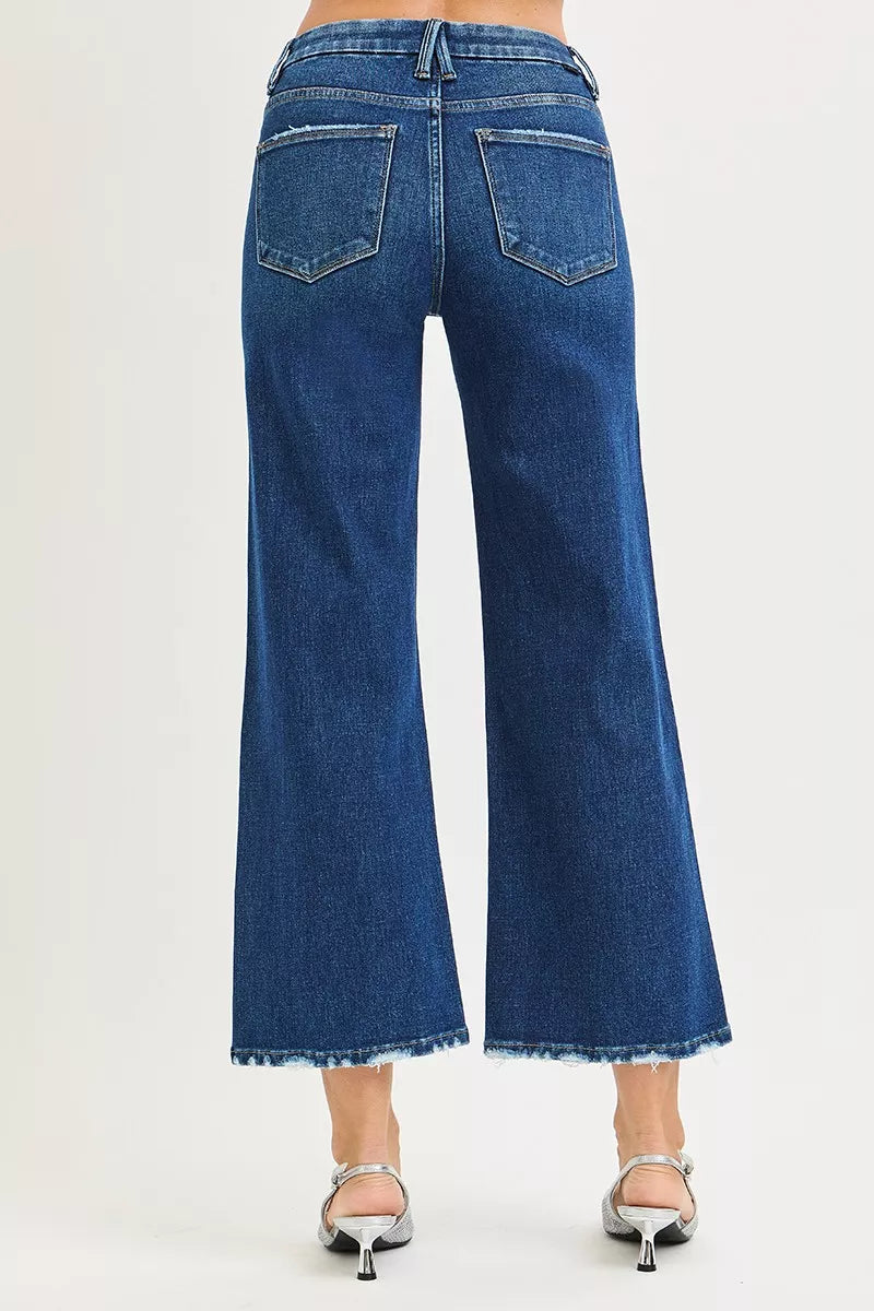 Blue jeans worn by a person on a white background
