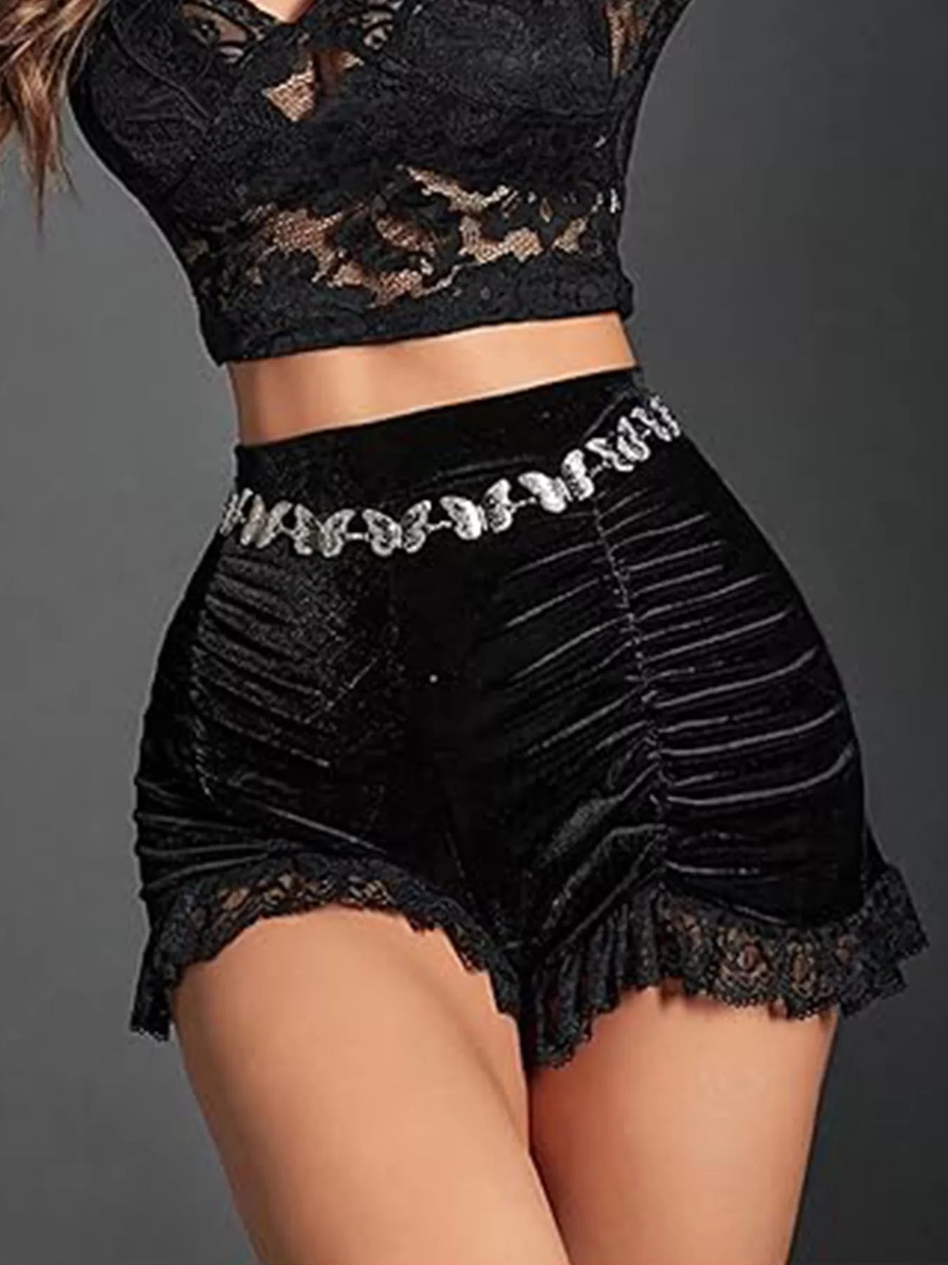 Black lace top and shorts set on a gray background