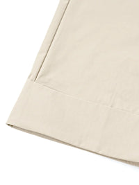 Close-up of beige fabric with a subtle pattern on a white background