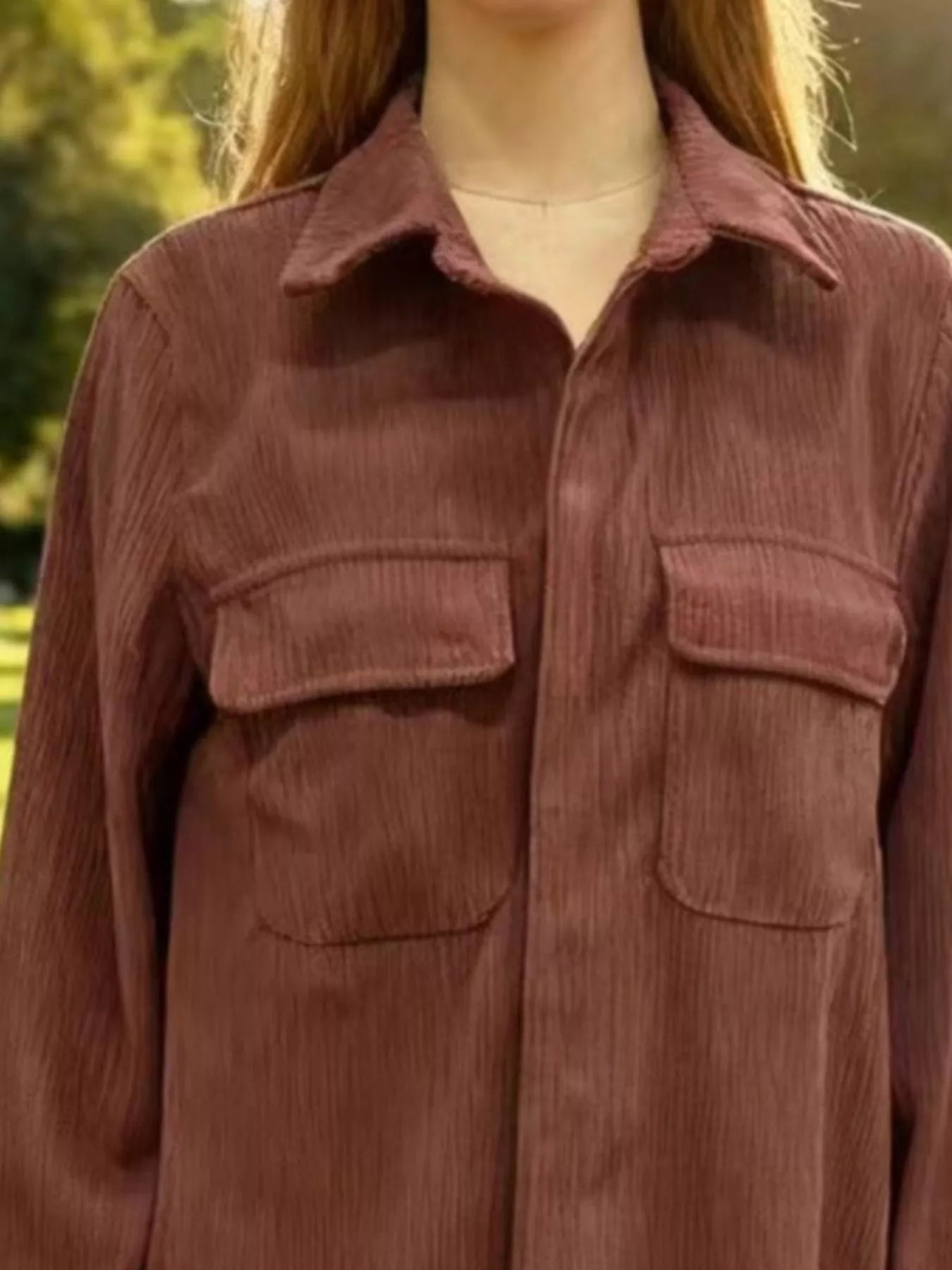 Brown corduroy shirt worn by a person with a blurred natural background