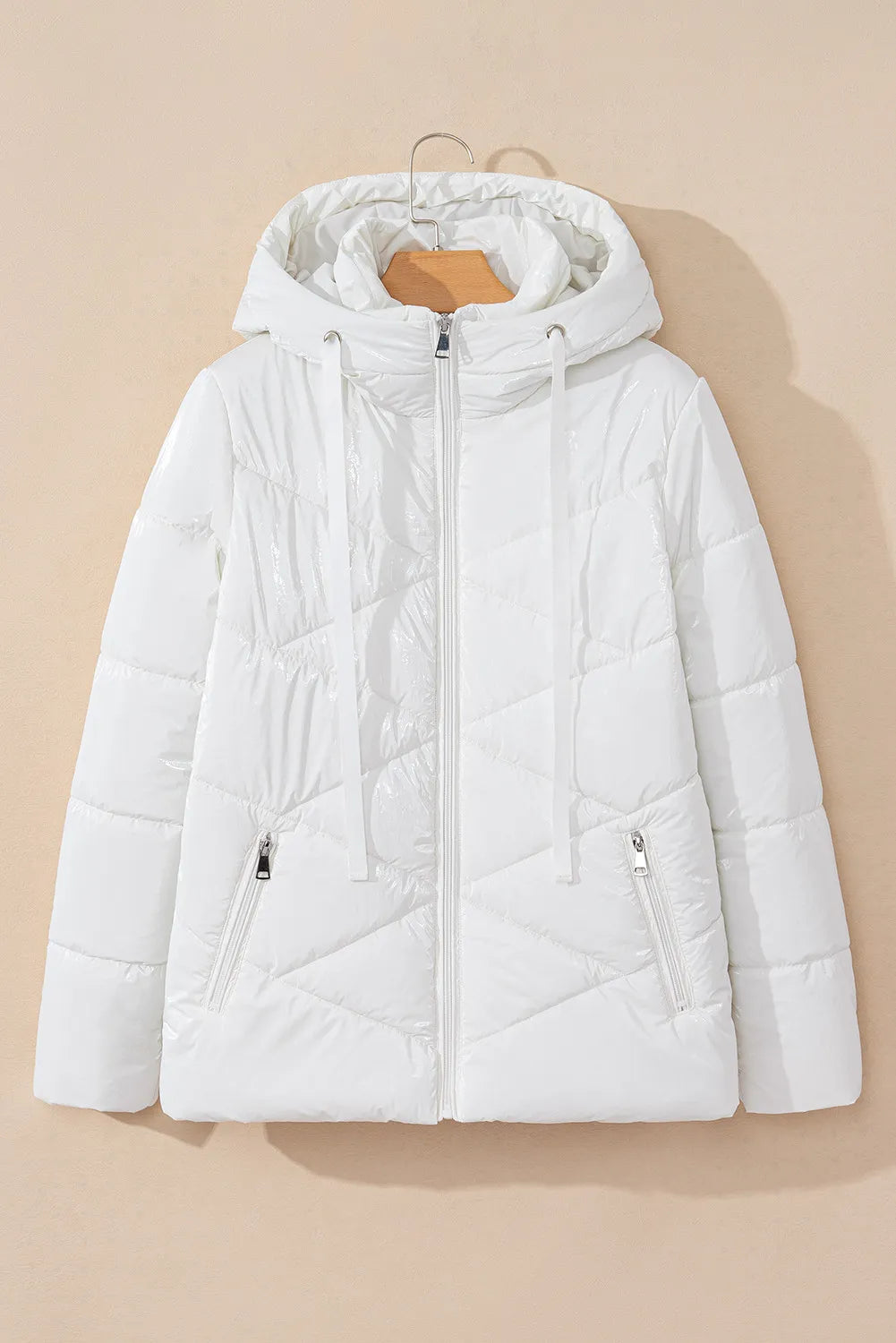 White puffer jacket on a beige background