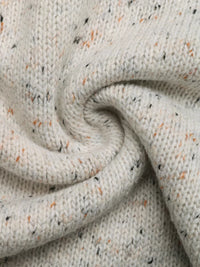 Close-up of textured beige fabric with speckles