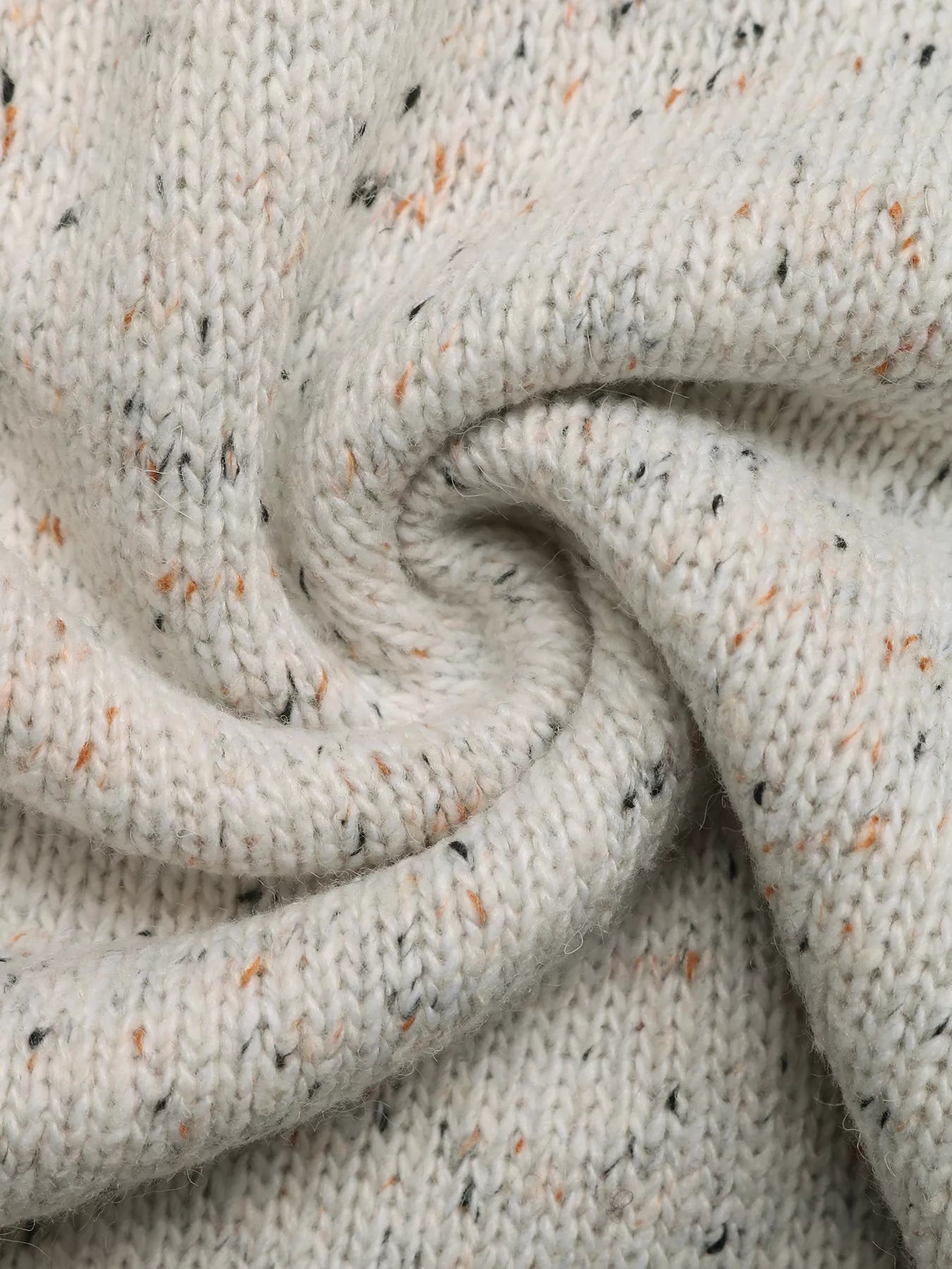 Close-up of textured beige fabric with speckles