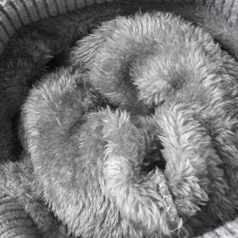 Close-up of a textured gray fabric with a basket in the background