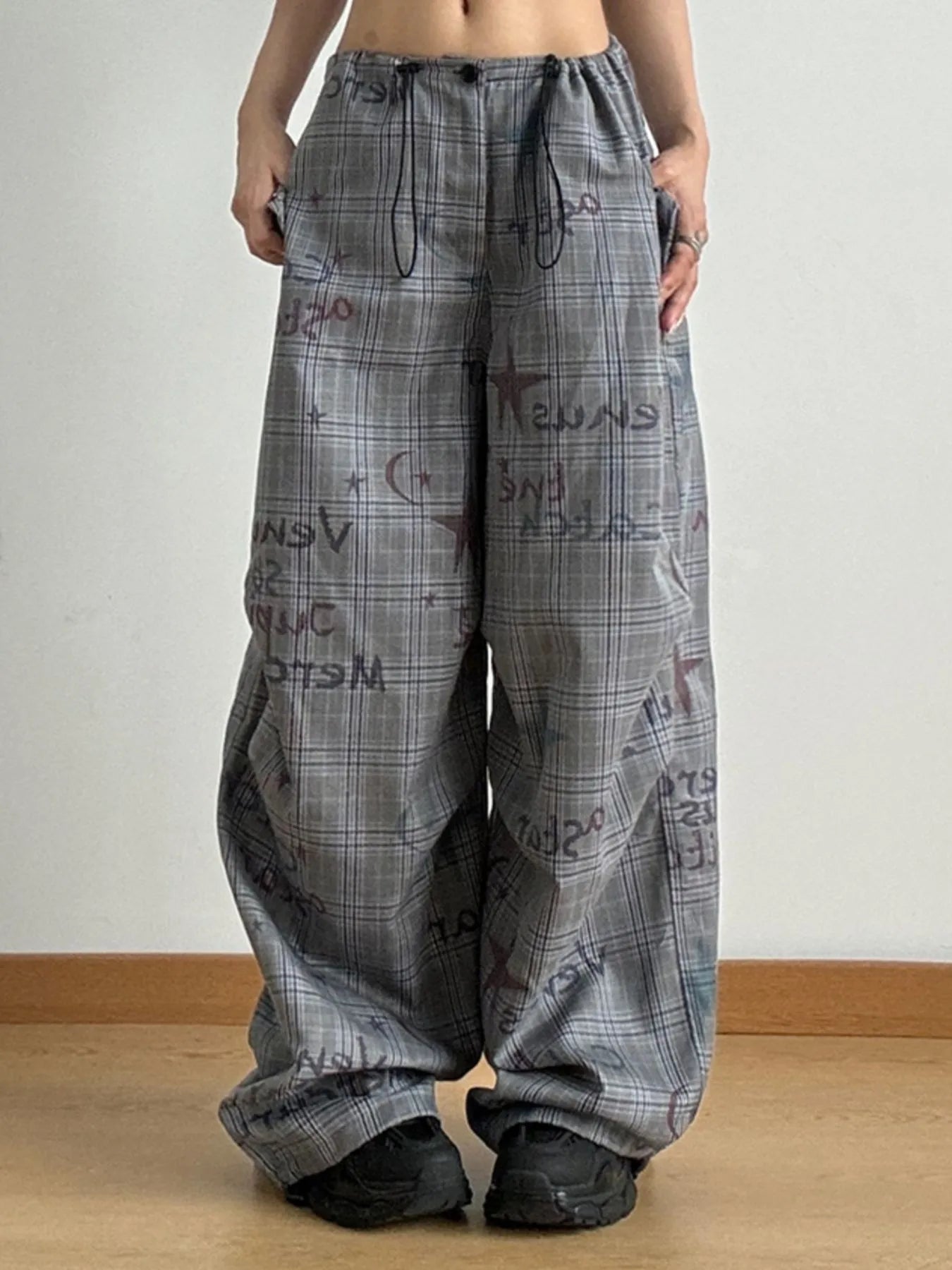 Person wearing plaid pants with text on a plain background